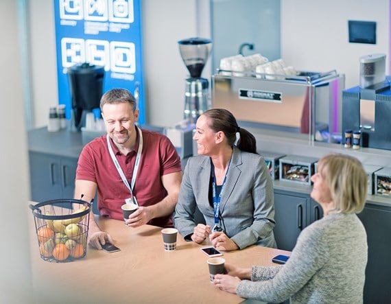 Caverion people collaborating around a table in Stockholm Sweden.jpg